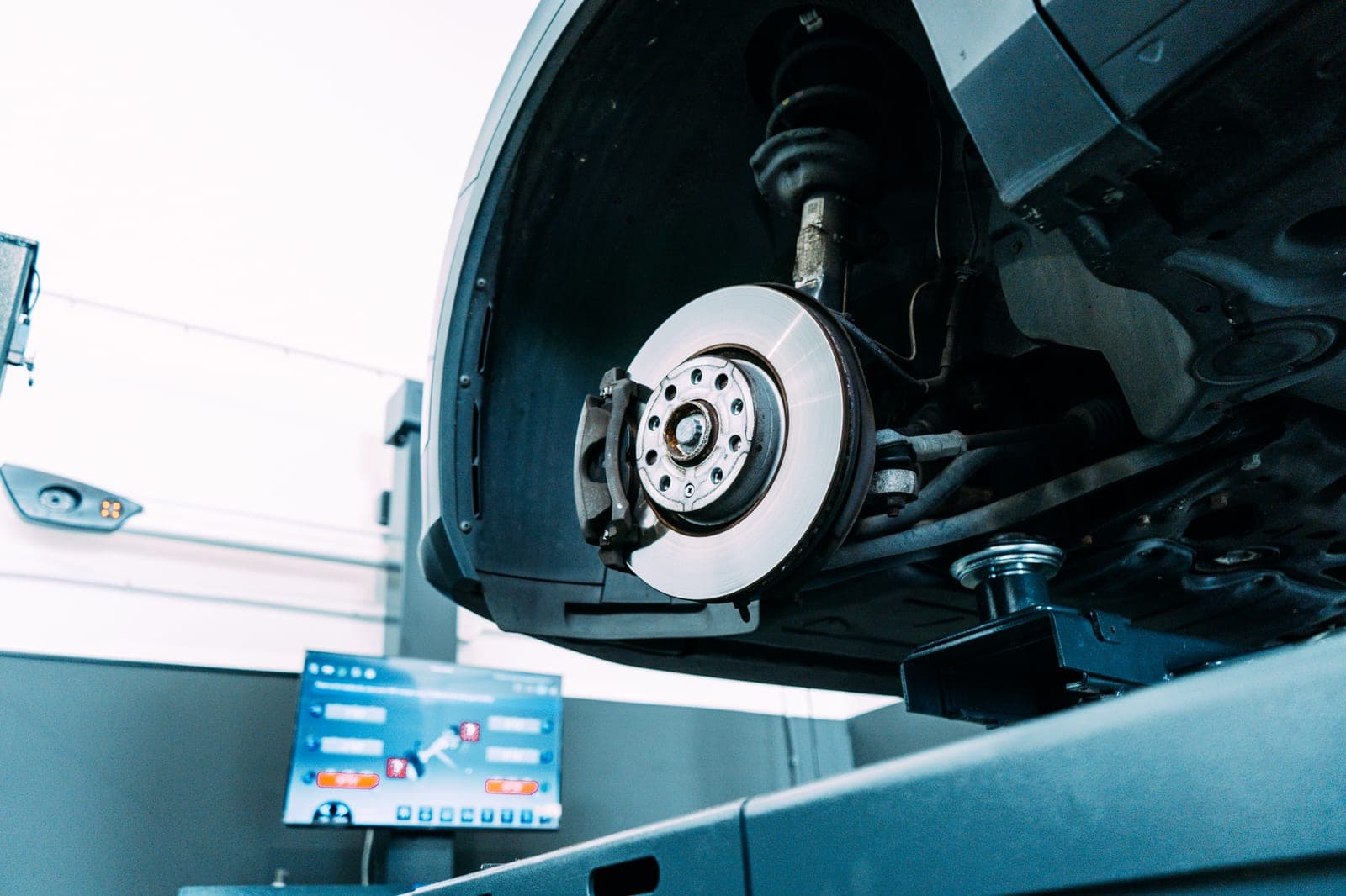 Auto op de brug met het wiel eraf tijdens een bandenwissel bij FlexAPK in Almere